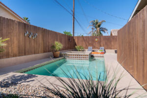Modern Southern California backyard pool surrounded by low-maintenance landscaping.